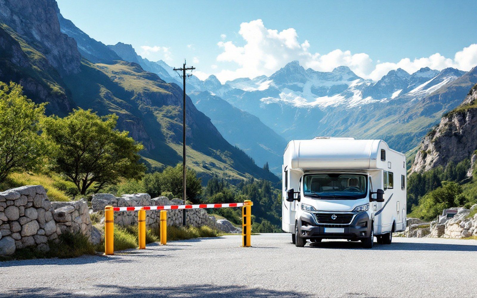 A camper parked beside a height barrier at the entrance to a car park